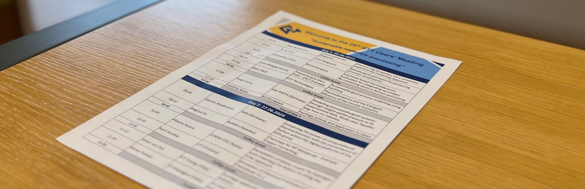 USERS' MEETING 2025: 4 - 6 JUNE, FORUM M, AACHEN, GERMANY & ONLINE overlaid on an image of the 2024 program on a wooden table.