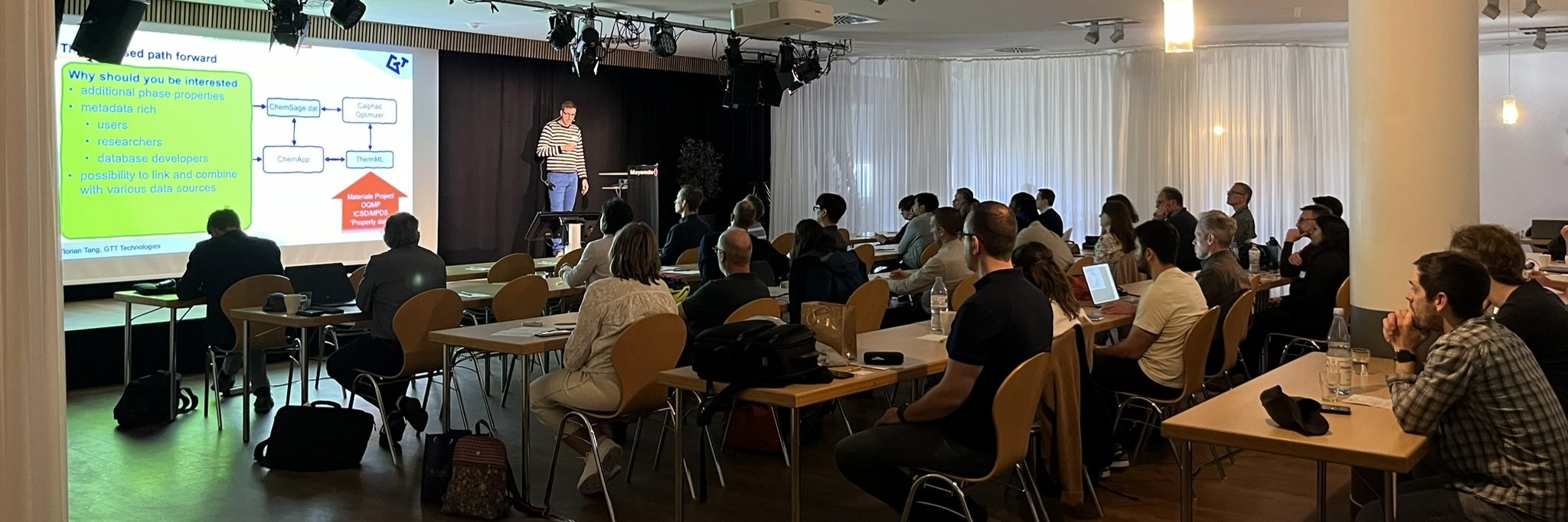 Speaker presenting at the Users’ Meeting with an audience attending a technical session